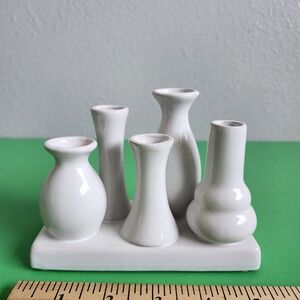 White ceramic bud vase set features five individual vases. 5.62 X 2.75 X 4.25